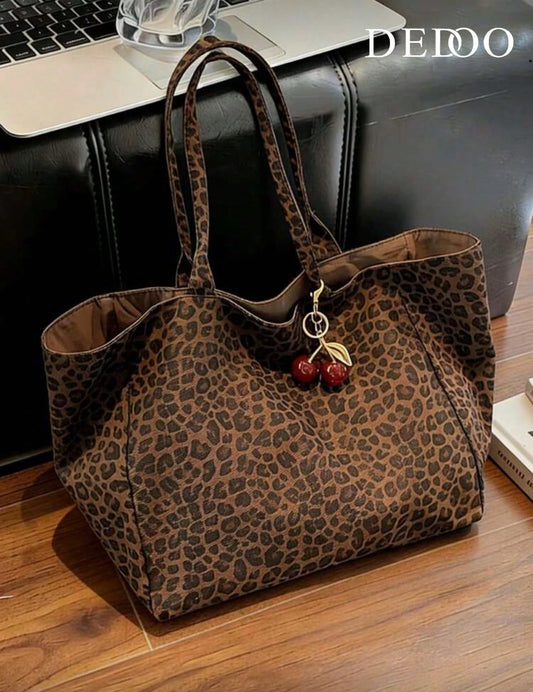 Large Capacity Women's Brown Tote Bag With Red Cherry Pendant. Featuring Leopard Print Design And Sturdy Dual Top Handles For Shoulder Or Hand Carry. Suitable For Storing Daily Essentials Such As Lips