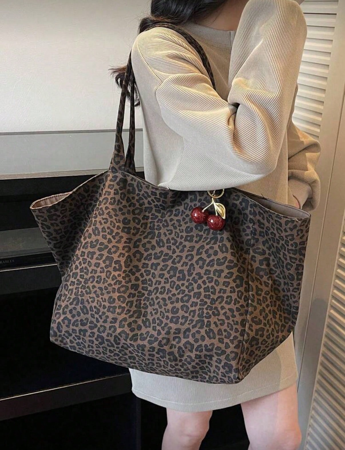 Large Capacity Women's Brown Tote Bag With Red Cherry Pendant. Featuring Leopard Print Design And Sturdy Dual Top Handles For Shoulder Or Hand Carry. Suitable For Storing Daily Essentials Such As Lips