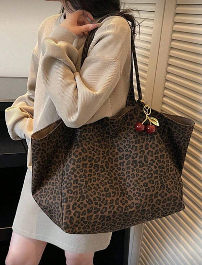 Large Capacity Women's Brown Tote Bag With Red Cherry Pendant. Featuring Leopard Print Design And Sturdy Dual Top Handles For Shoulder Or Hand Carry. Suitable For Storing Daily Essentials Such As Lips
